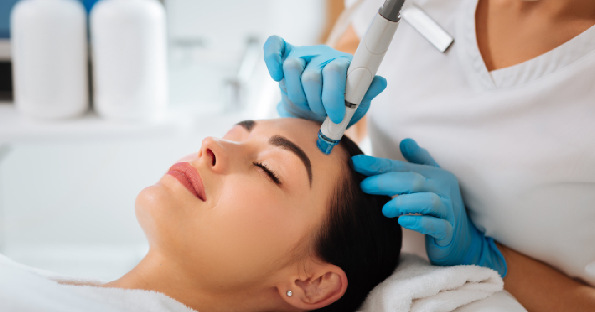 A woman receiving a HydraFacial treatment at a skincare clinic in Bothell, WA