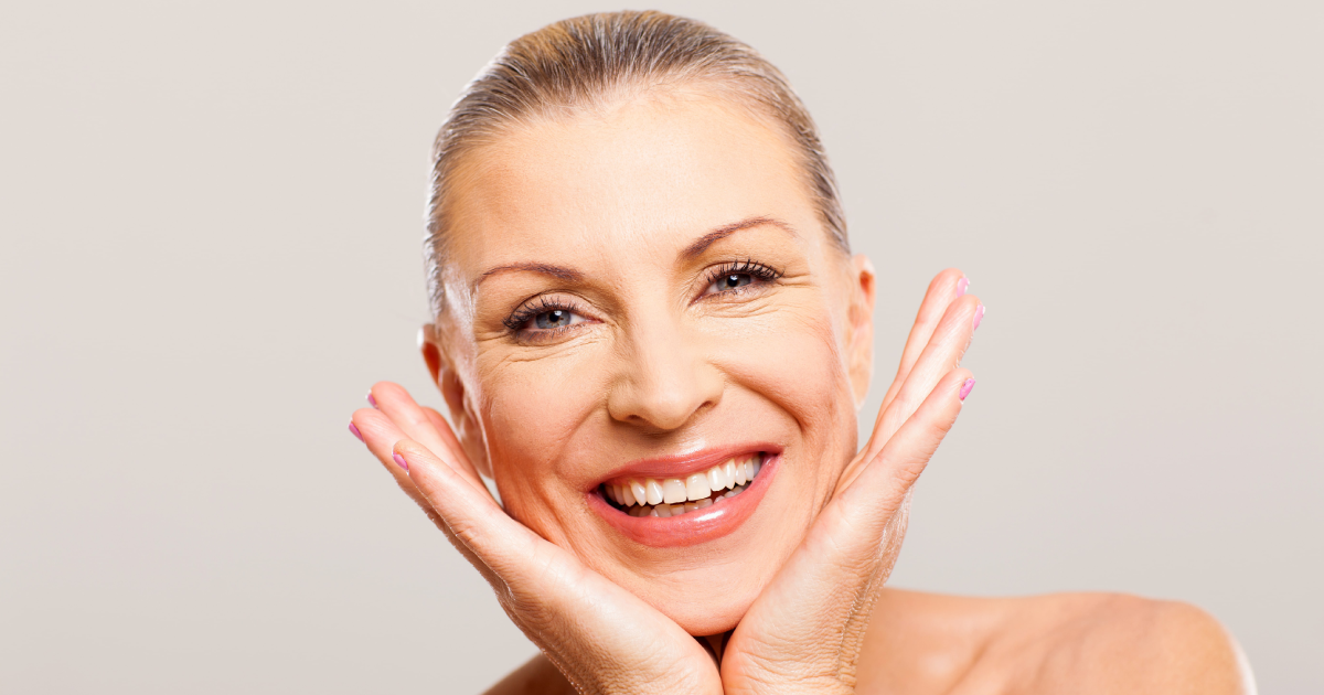 Smiling woman with glowing skin after collagen stimulator treatment in Bothell, WA